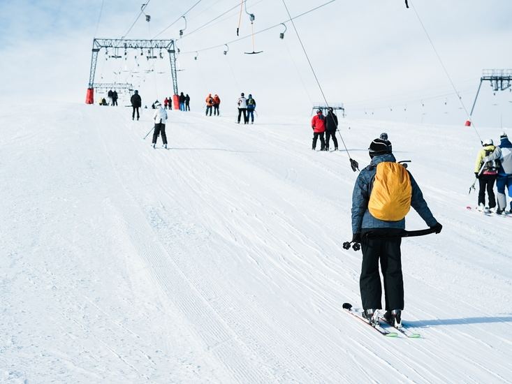 Skiers queuing for a drag lift