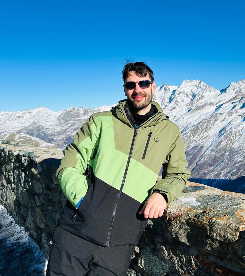 Jamie Burgess at a mountain viewpoint in the Alps